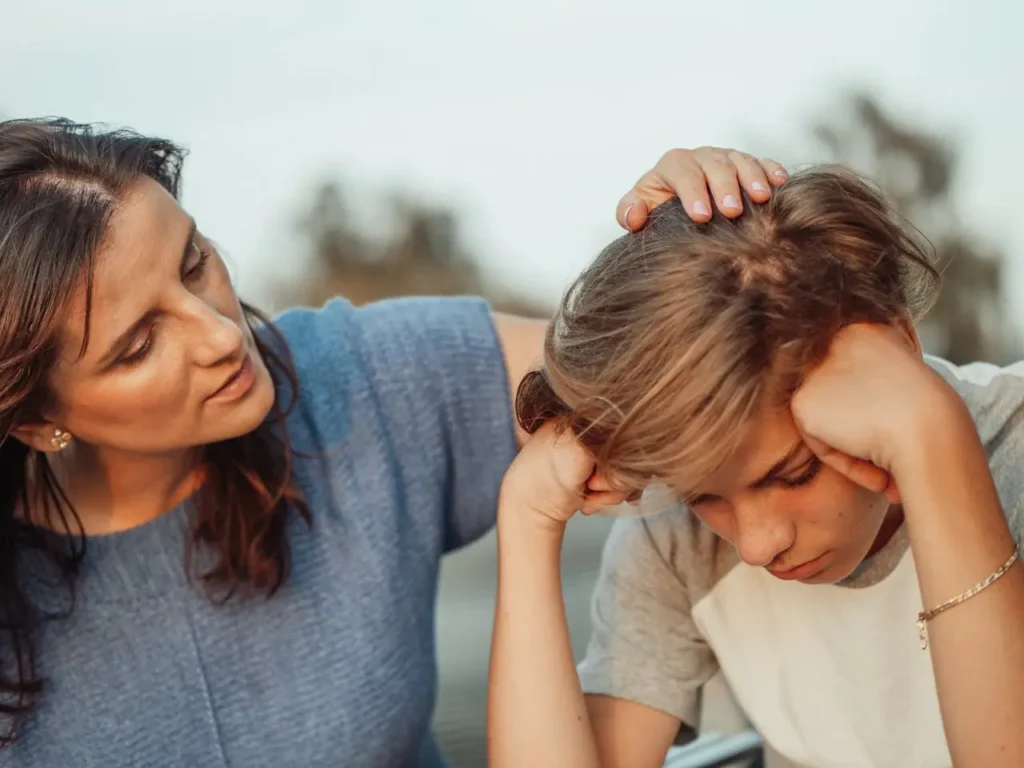 mother and teenage son serious conversation living room